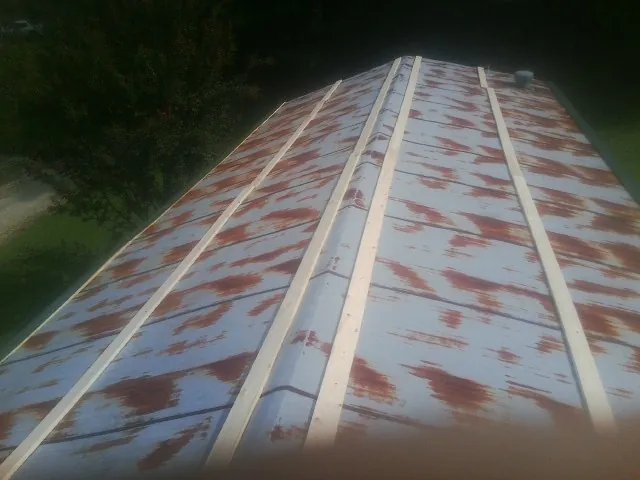 Rusted metal roof panels with new wood purlins before replacement — Storm Damage Roof Repair in Croydon by Roofing Brothers